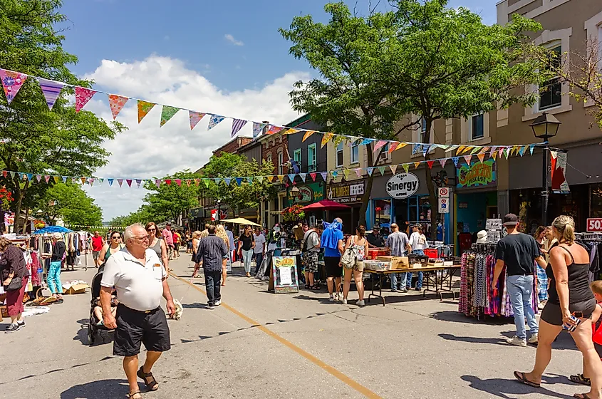 Tourists and locals walking on Mississauga Street in Orillia during a summer street festival