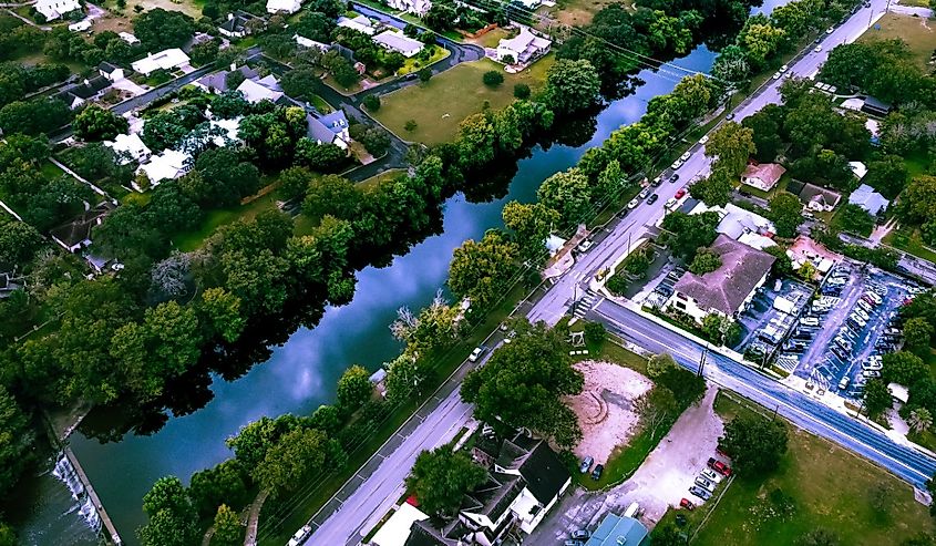 Sunset high altitude aerial view of the Guadalupe river and river road in Boerne, Texas