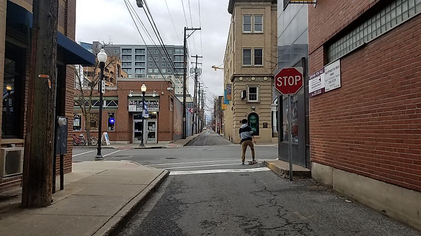 Person skating in Downtown State College taken on Calder way near Allen st. facing Southwest