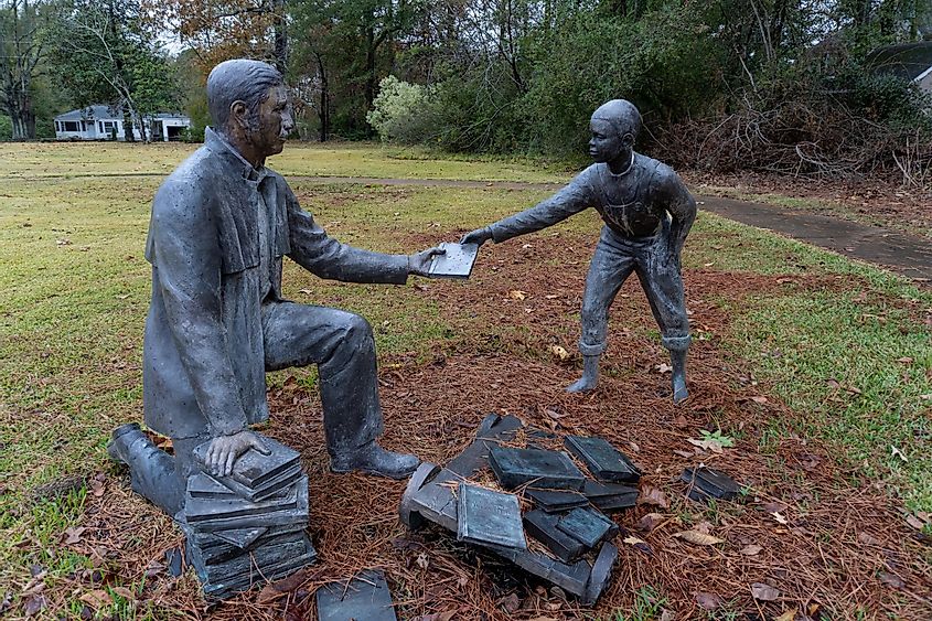 Corinth Contraband Camp at Shiloh National Military Park in Corinth, Mississippi, where African-Americans fled for freedom during the Civil War, featuring a statue of a man giving a book to a child.