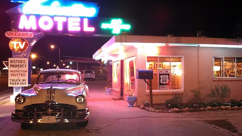 Blue Swallow Motel at night with a classic car parked in front, located on Route 66 in Tucumcari, New Mexico.