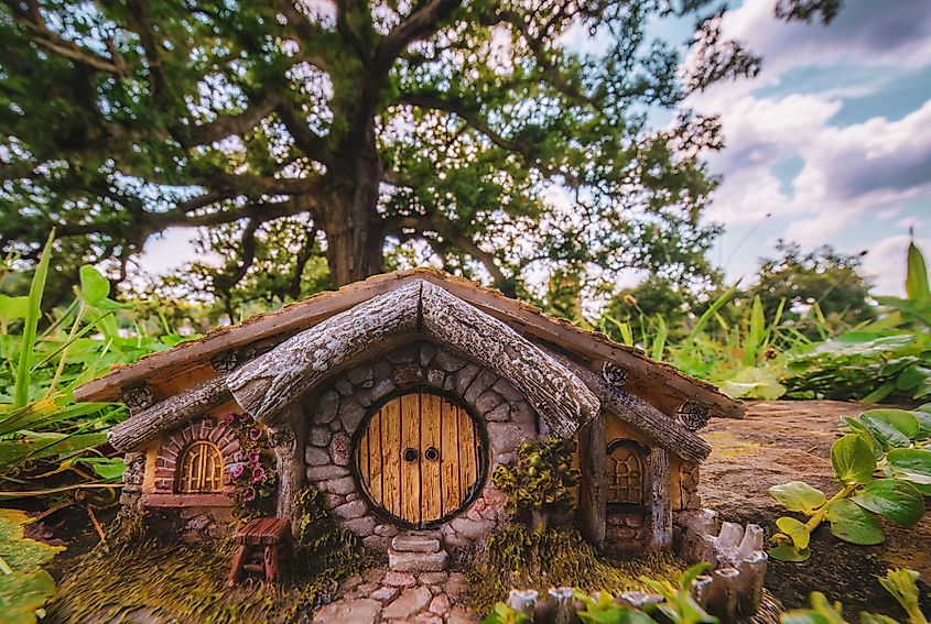 Replica hobbit house nestled near the Logan Oak tree in Logan, Ohio, creating a whimsical foreground in this scenic composition.