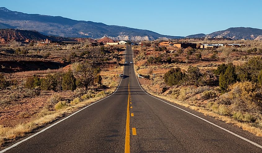 Scenic road in the desert during a vibrant sunny sunrise. Taken on Route 24 near Torrey, Utah, United States of America.