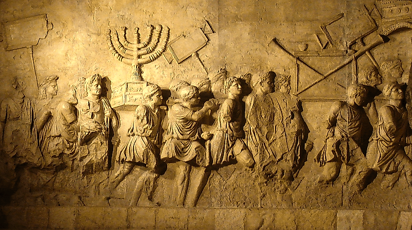 Replica of Rome's Arch of Titus relief showing the Temple menorah and other spoils from Jerusalem (derivative work: Steerpike (talk)Arc_de_Triumph_copy.jpg: user: בית השלום, Public domain, via Wikimedia Commons)