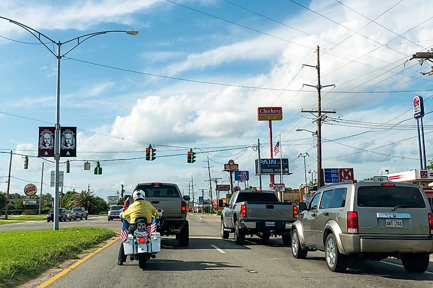 Cars and a bicycle stopped at a traffic light in Sulphur, Louisiana, United States