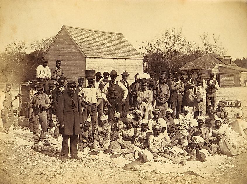 A Union soldier stands with African Americans on the plantation Thomas F. Drayton, Hilton Head Island, South Carolina, 1862. Photo by Henry P. Moore, May 1862.