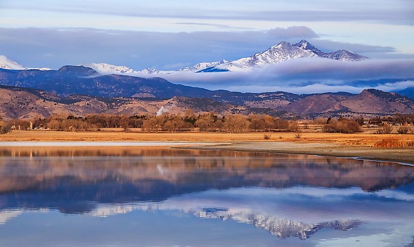 A view of McIntosh Lake, Longmont, Colorado, at sunrise with Meeker and Longs Peak in the background.