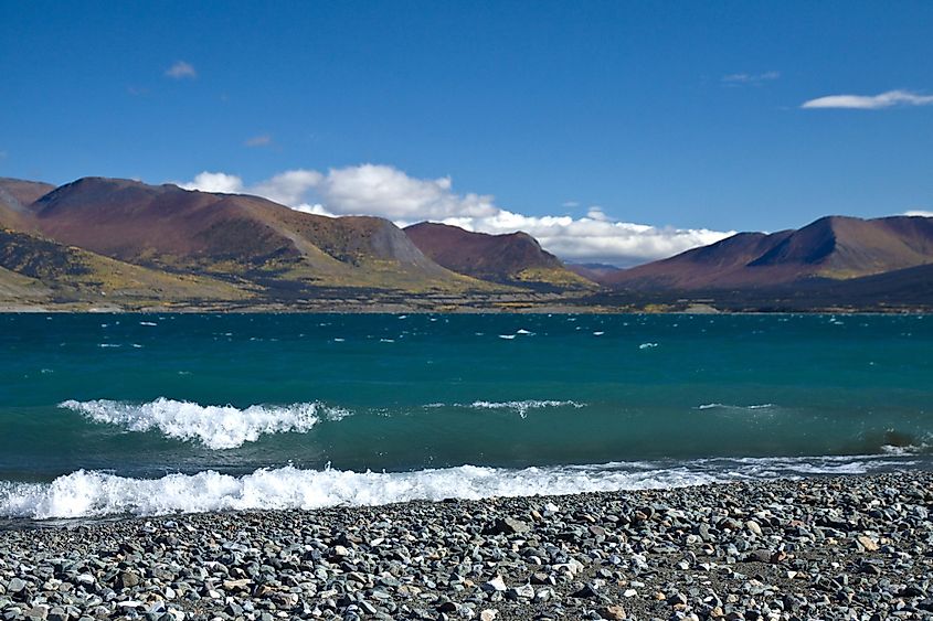 Blue green waves breaking on the gravel shore of Kluane Lake, Kluane National Park, Yukon, Canada