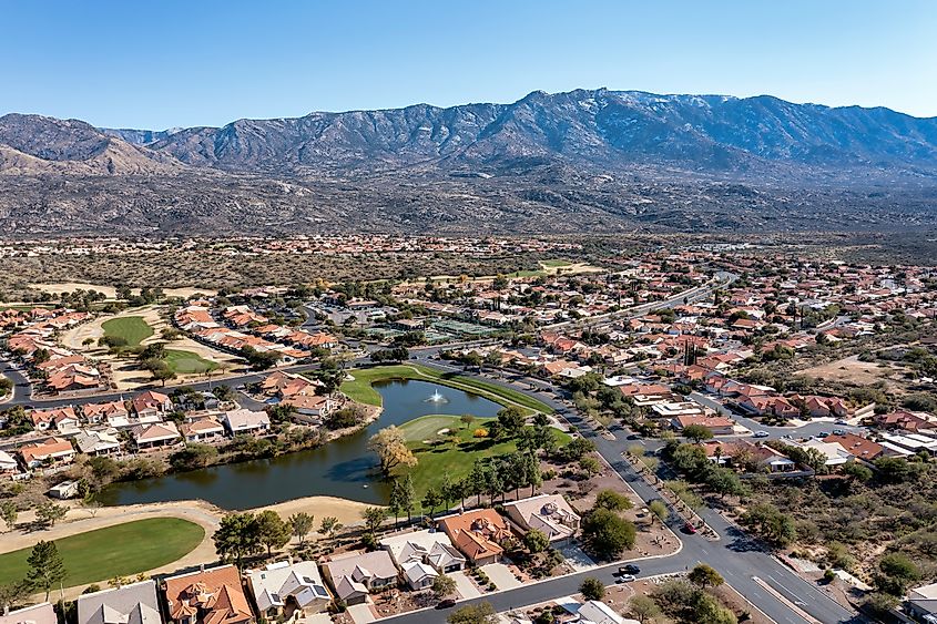 Aerial view of a suburban residential community with the Catalina Mountains in the background.