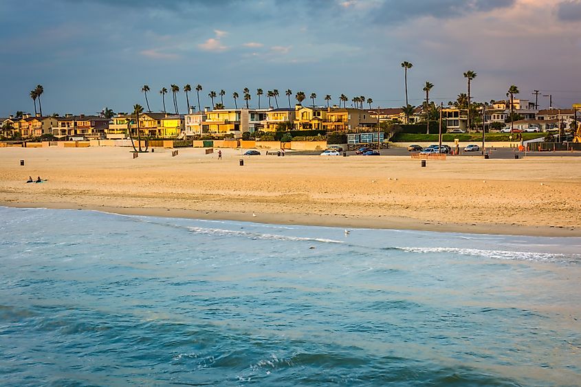 Waves in the Pacific Ocean and view of the beach at sunset in Seal Beach, California