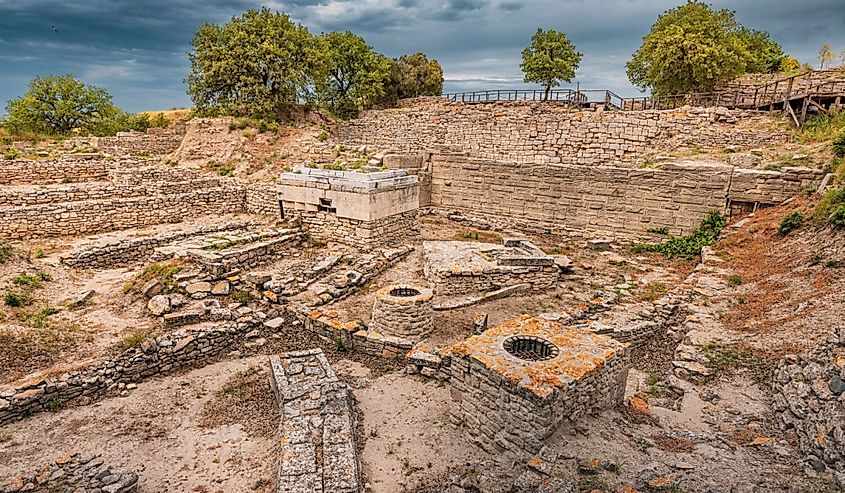 Troy VI megaron and retaining walls under cloudy sky, located in Hisarlik, Turkey