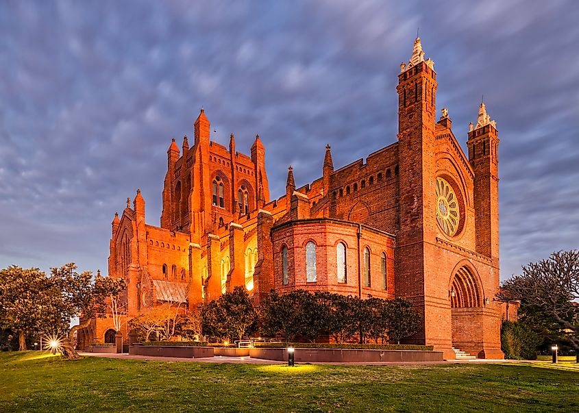 Historic cathedral in city of Newcastle in Australia at sunset with bright lights.