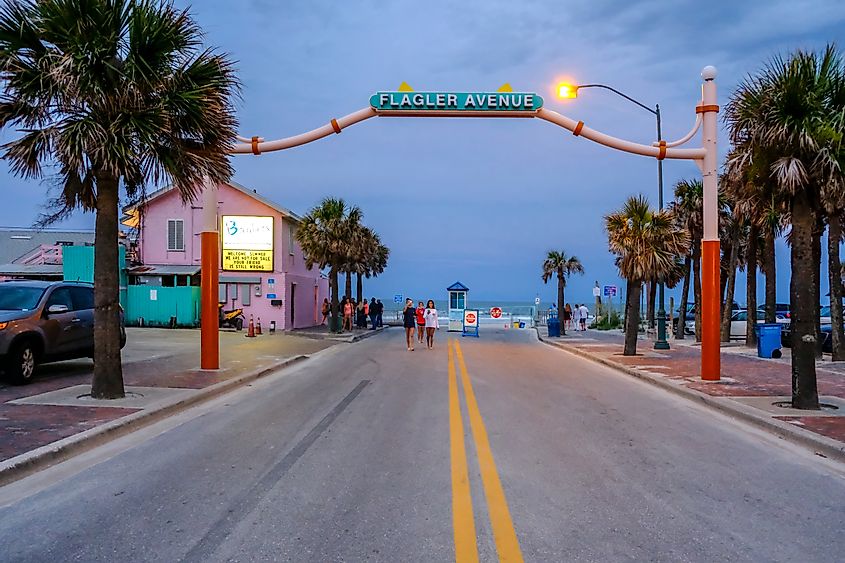 Flagler Avenue sign at the beach entrance in New Smyrna Beach on a summer evening, via Chris Higgins Photography / Shutterstock.com