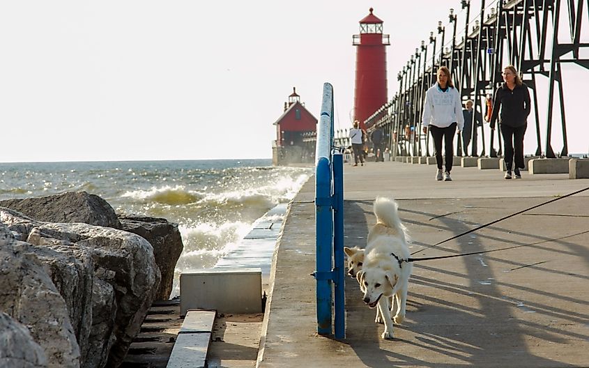 Evening walks on Pier leading to the historic lighthouse in Grand Haven, Michigan