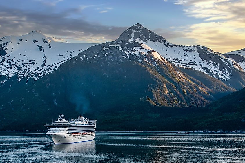 Evening sky over the Alaskan mountain range, boats on the Inside Passage.
