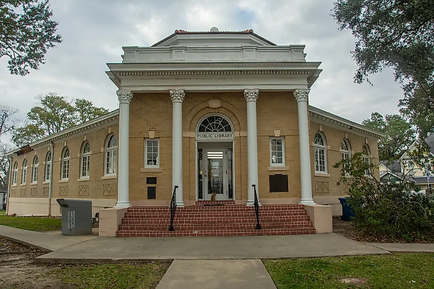 Editorial Photo Credit: Nina Alizada via Shutterstock. Jennings, USA - December 7, 2022 -  Jennings Carnegie Public Library with buff brick and white woodwork trim, octagonal rotunda and Corinthian columns in Jennings, Louisiana