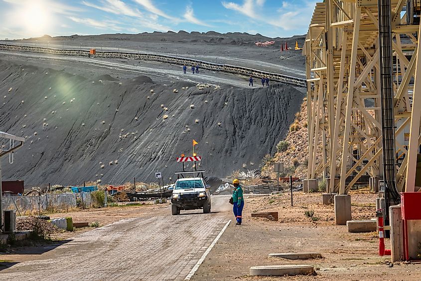 Workers walking in top of the tailings of kimberlite at a diamond mine in Botswana