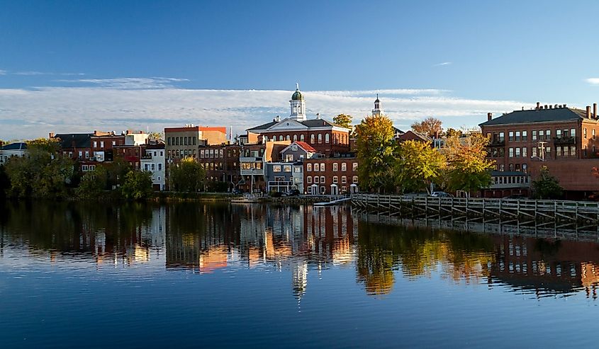 The river front buildings of Exeter, New Hampshire are seen reflected in the water