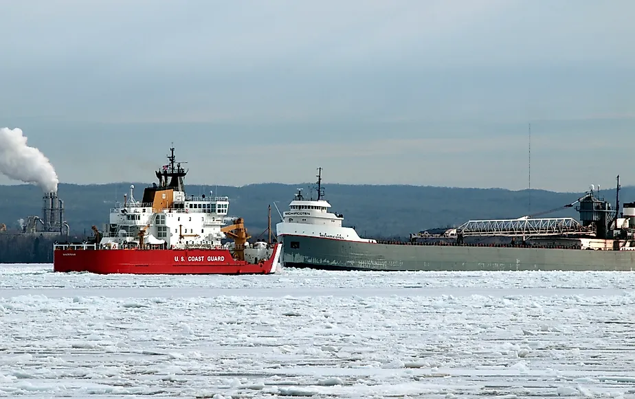 US Coast Guard ship and a grey cargo freighter near the Soo Locks. Editorial credit: T-I / Shutterstock.com