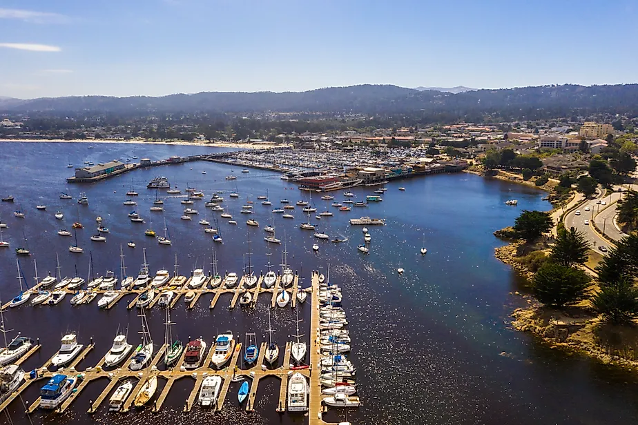 Aerial view of the Monterey Bay Aquarium, Pacific Grove with many yachts docked by the coastline in Monterey, central California.