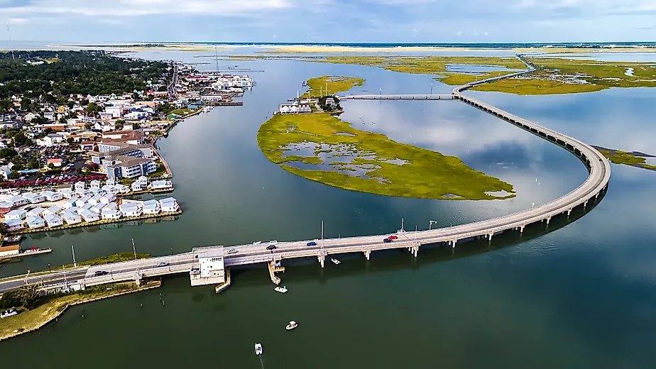 Drone view of Chincoteague bridge across the Chincoteague Bay in Virginia, showcasing views of the waterfront.