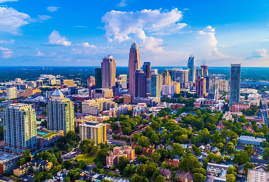 Charlotte North Carolina skyline on a bright sunny day with a few clouds in the sky.