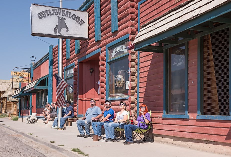 The exterior of Outlaw Saloon with a view of the street and mountains in Dubois, Wyoming. Image credit Sandra Foyt via Shutterstock