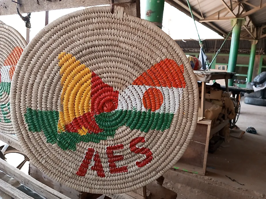 An artisan-made mat with an AES logo. By Barke11 - Own work, CC BY-SA 4.0, Wikimedia Commons.