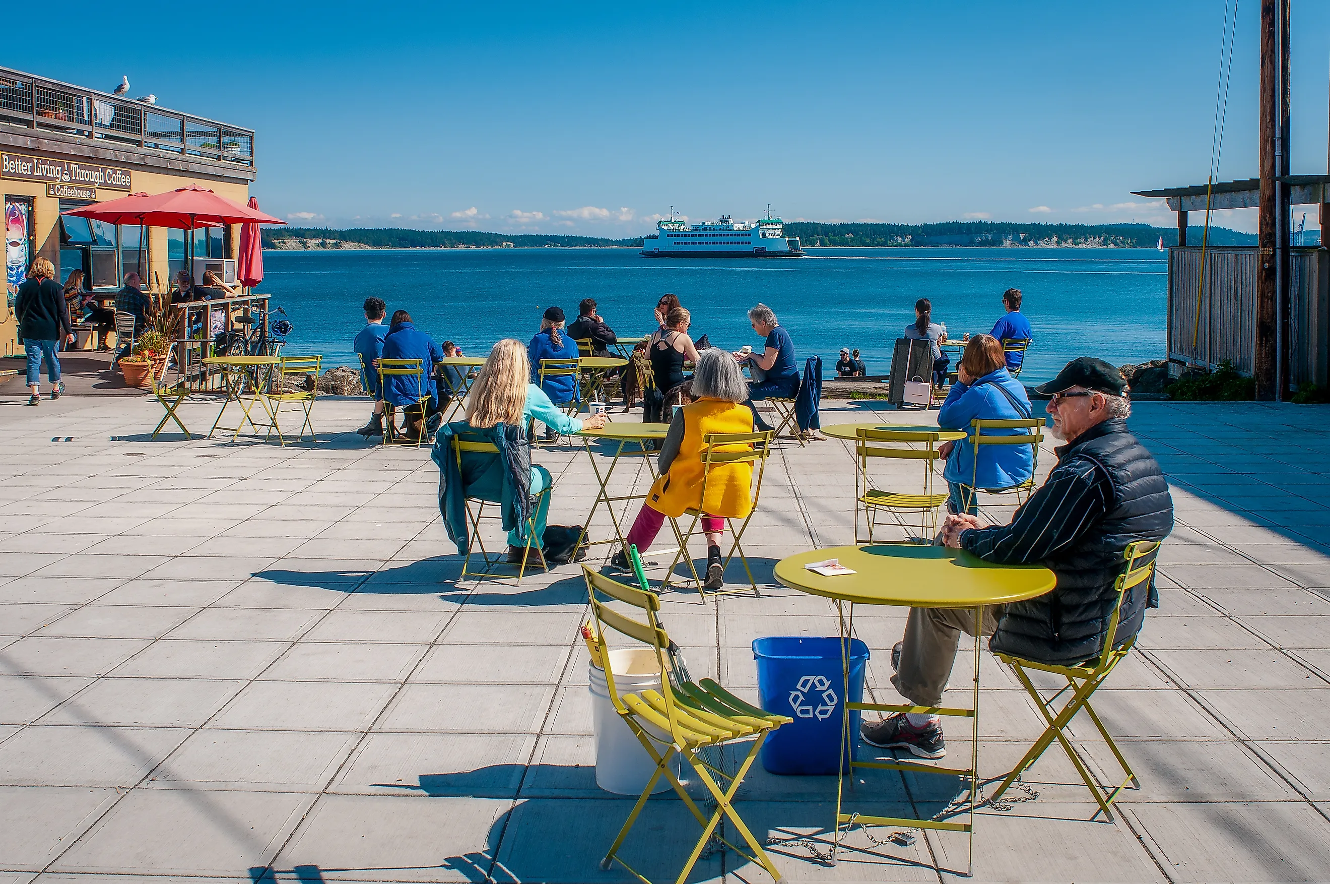 Port Townsend, Washington / United States - April 20, 2019: the Washington State ferry Kennewick steams out of Port Townsend past the Main Street Plaza where people enjoy the sunny day