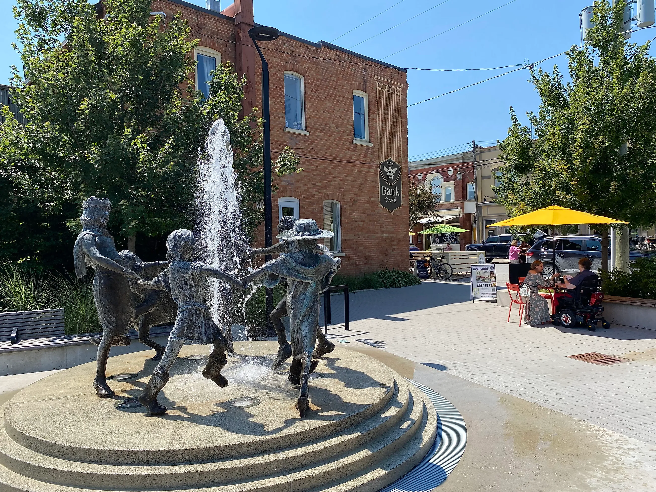 The sculpture fountain of Creemore’s Village Green courtyard flows into the sidewalk patio of the Bank Café. Photo Credit: Andrew Douglas