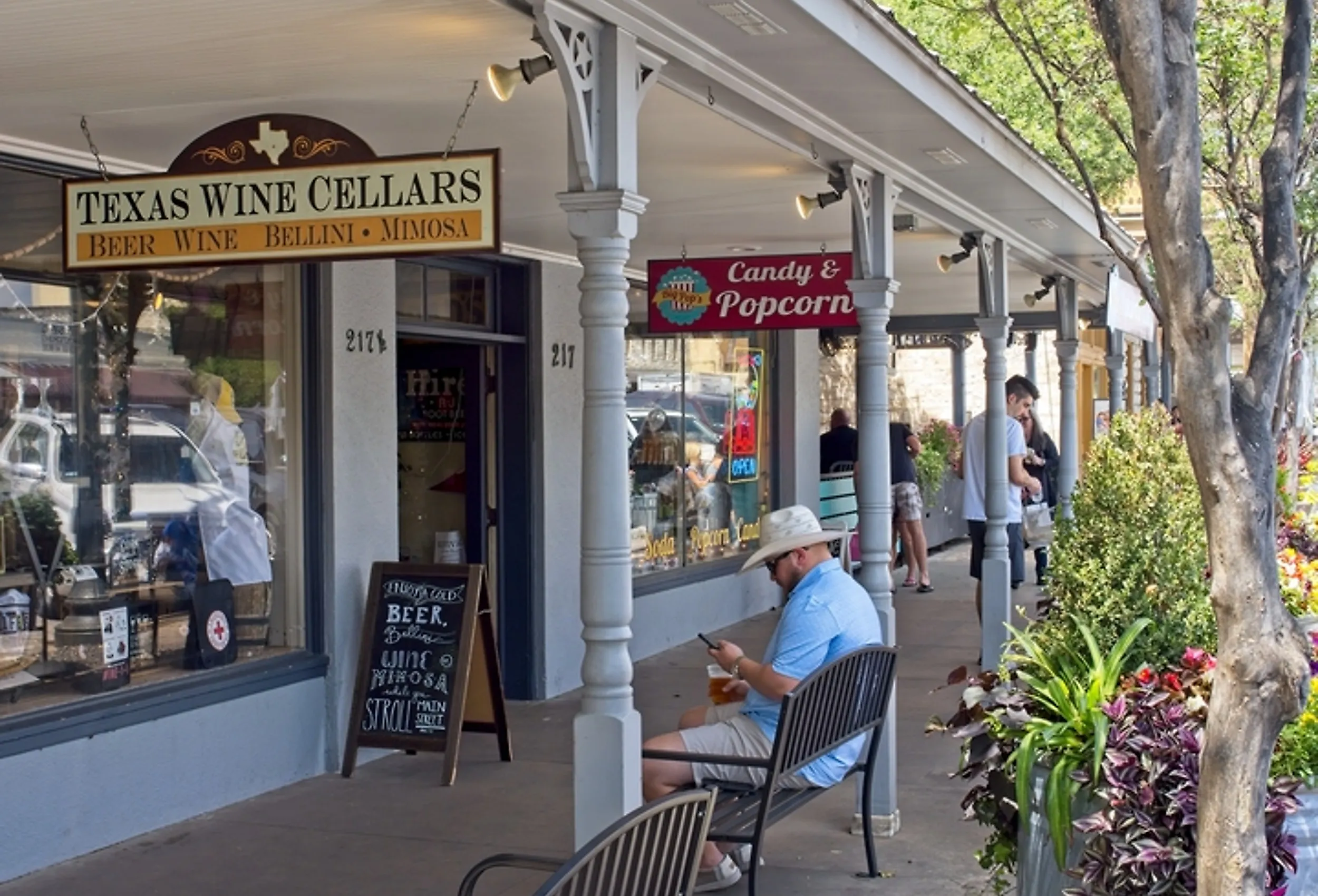 People walking around downtown Fredericksburg, Texas along the main street, via Peter Blottman Photography / iStock.com