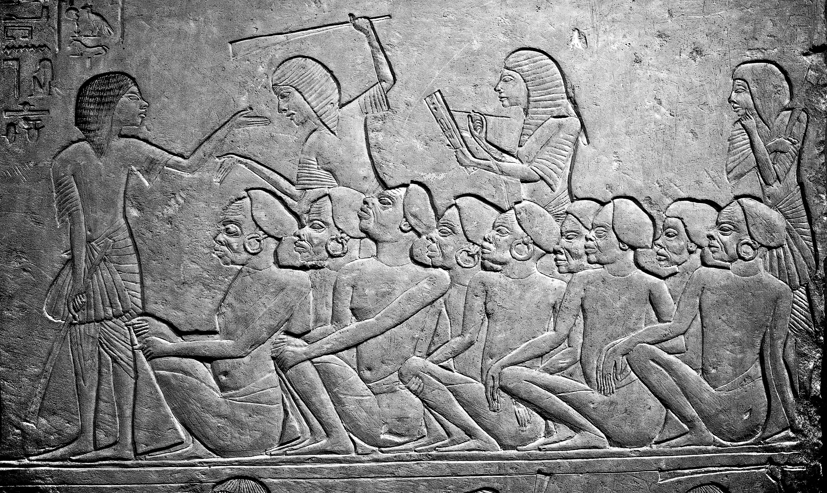 Kushite prisoners of war watched over by Egyptians, waiting to be deported into Egypt. 