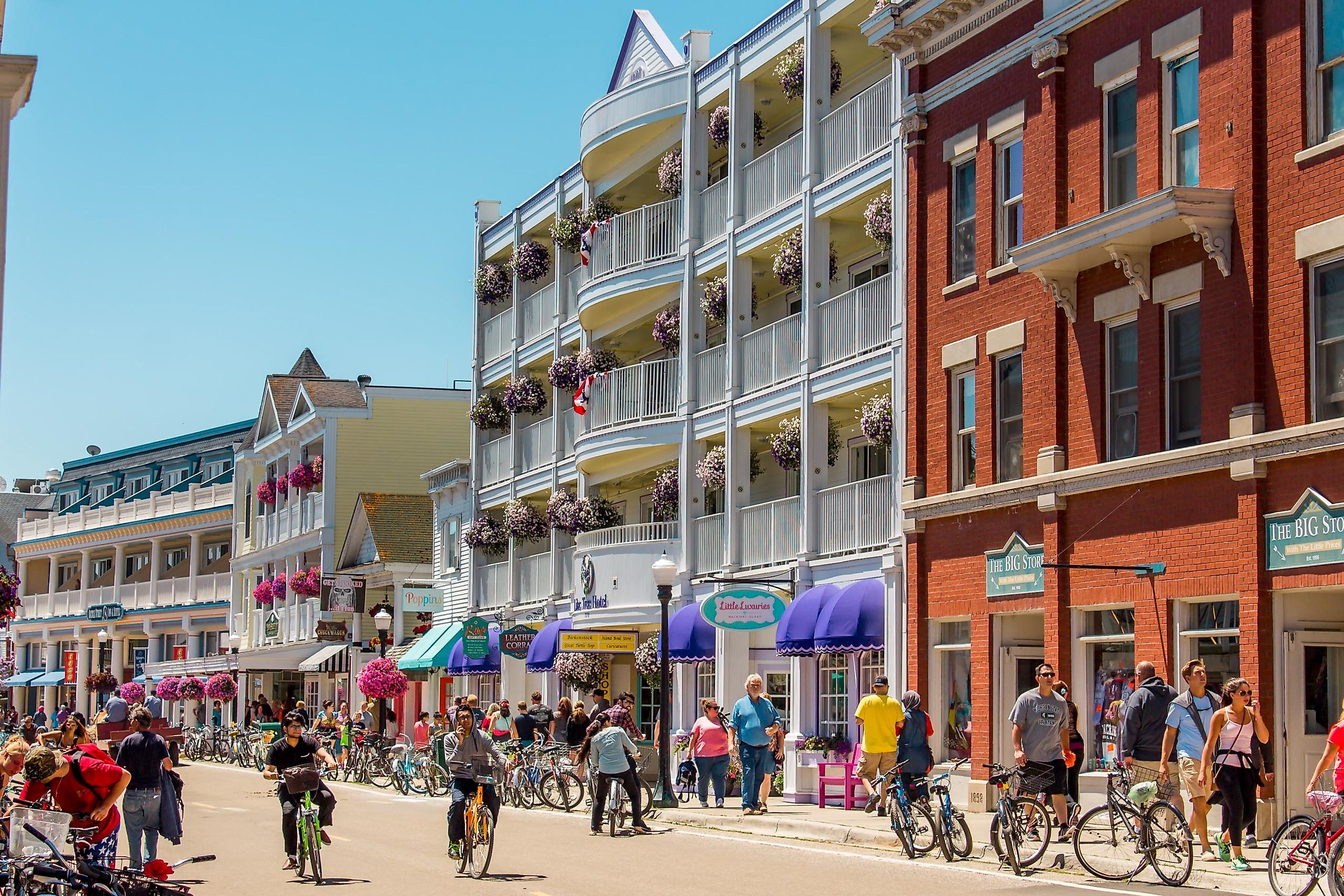 Bustling streets of downtown Mackinac Island during tourist season in Mackinac Island, Michigan, Editorial Credit: Michael Deemer via Shutterstock.