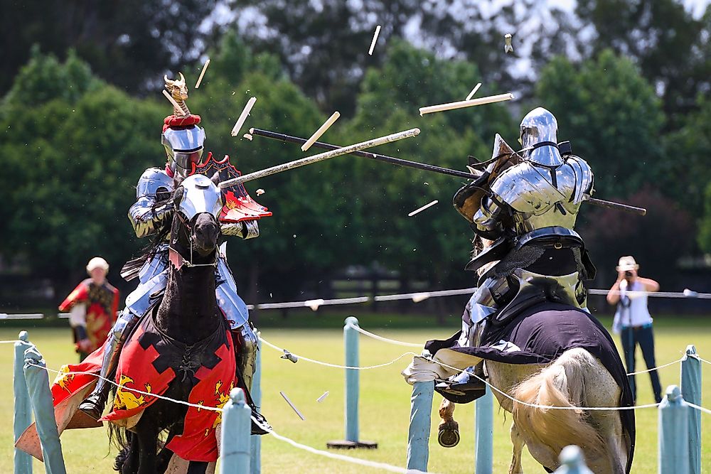 Men dressed up as knights compete in jousting.
