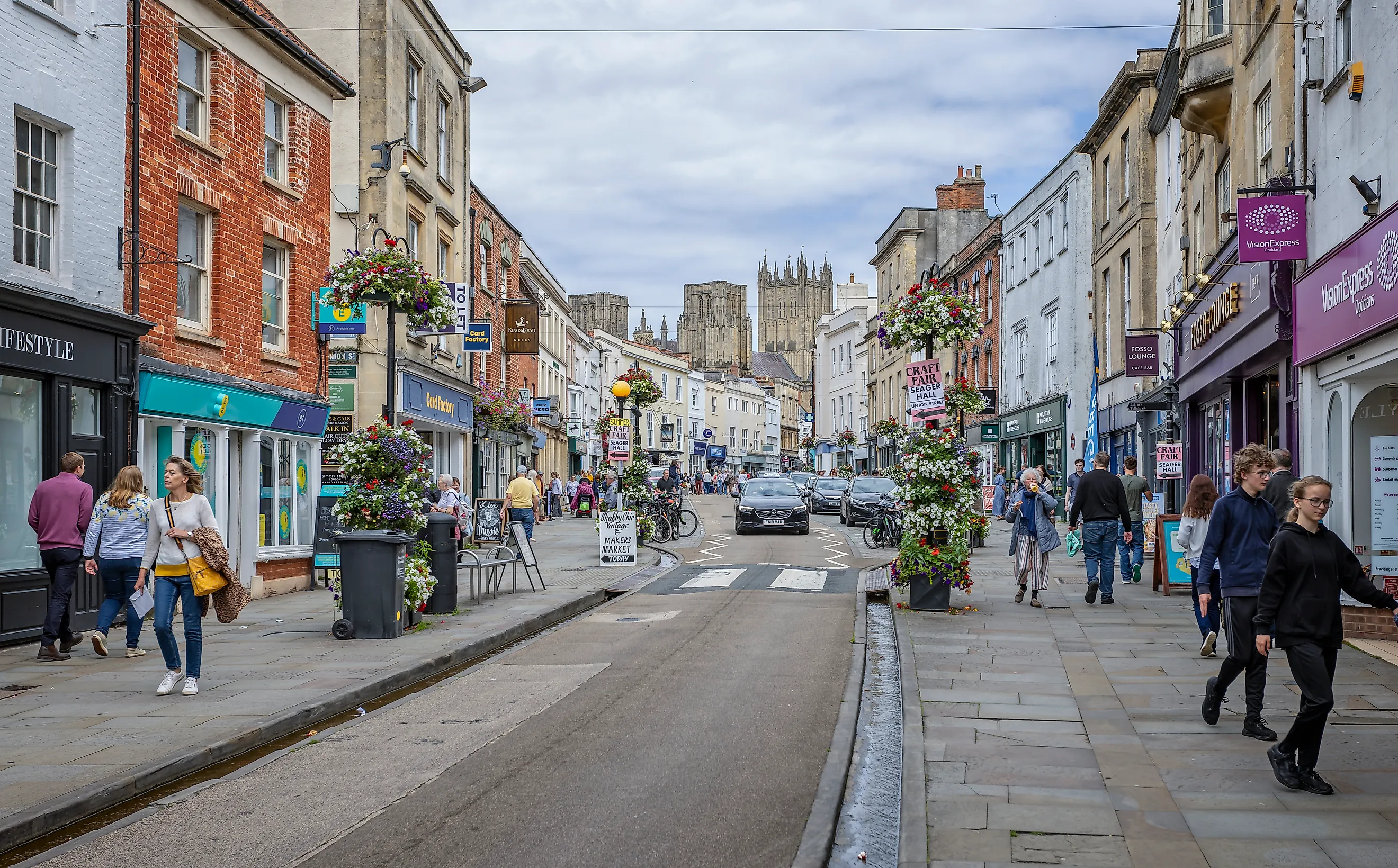 High Street Wells bustling with shoppers in Wells, Somerset