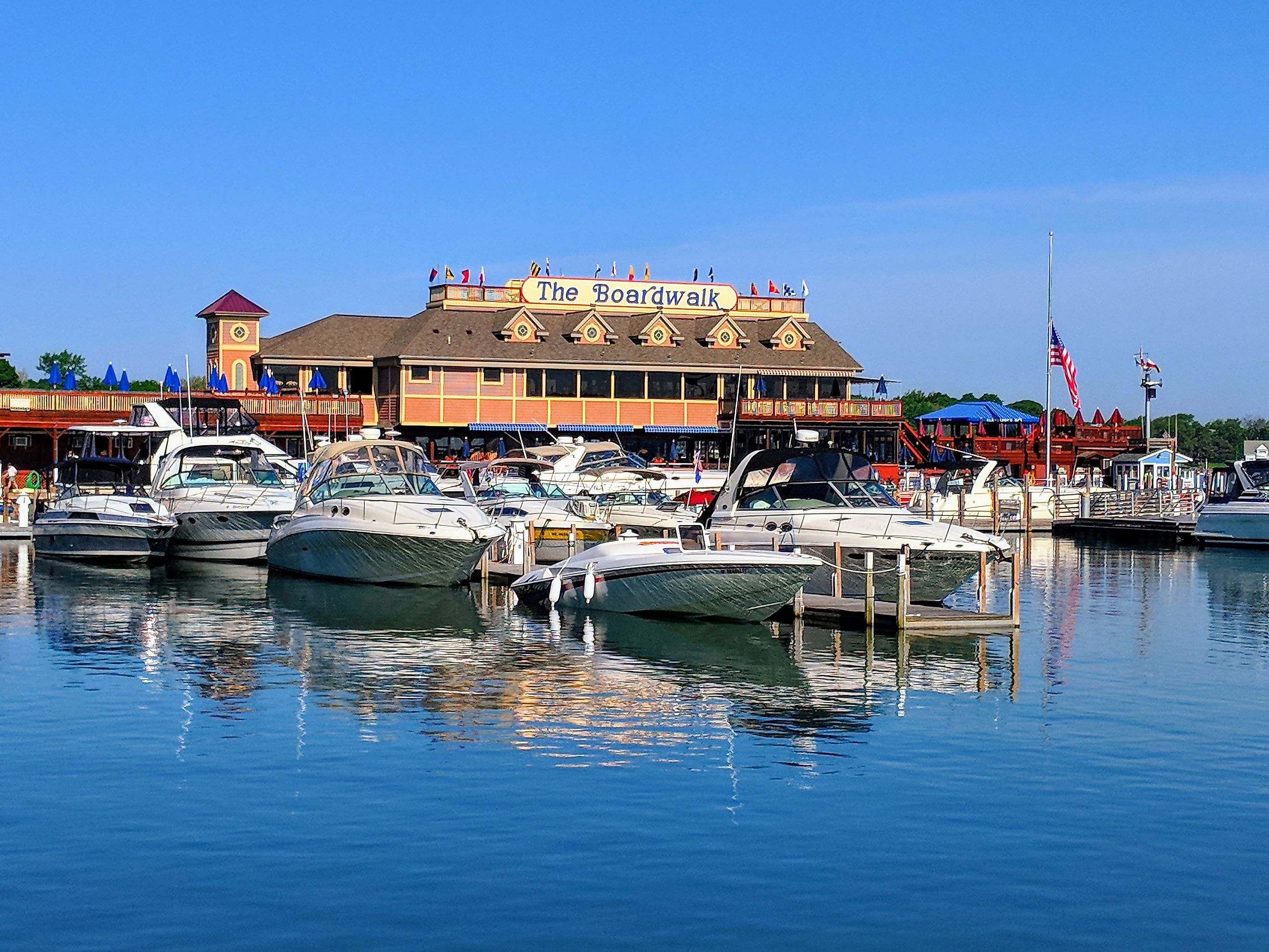 Put-in-bay, Ohio - May 27, 2018: Boats tied up at A-Dock with the famous Boardwalk restaurant in the background.