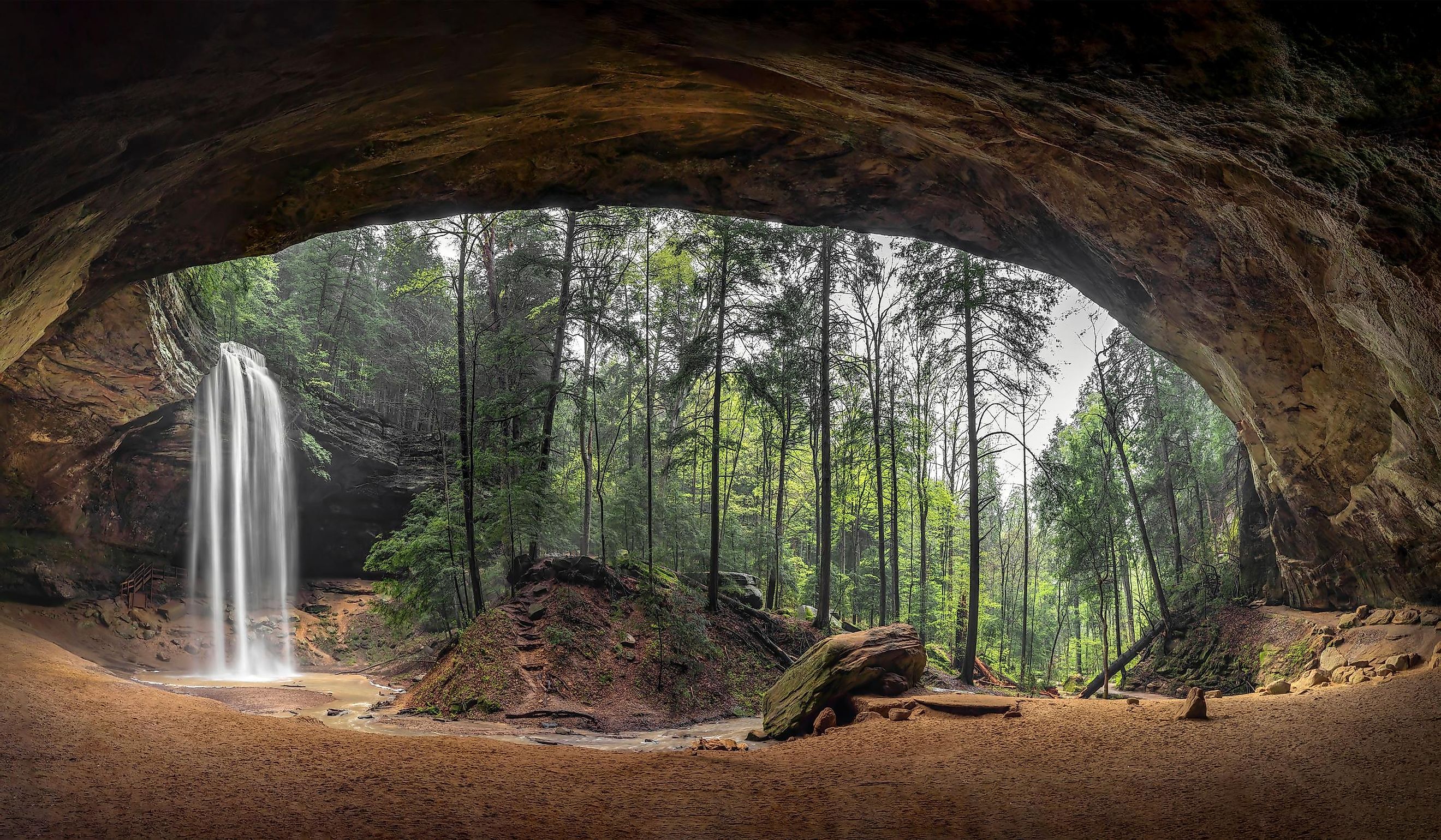 Located in the Hocking Hills of Ohio, Ash Cave is an enormous sandstone recess cave adorned with a beautiful waterfall after spring rains.
