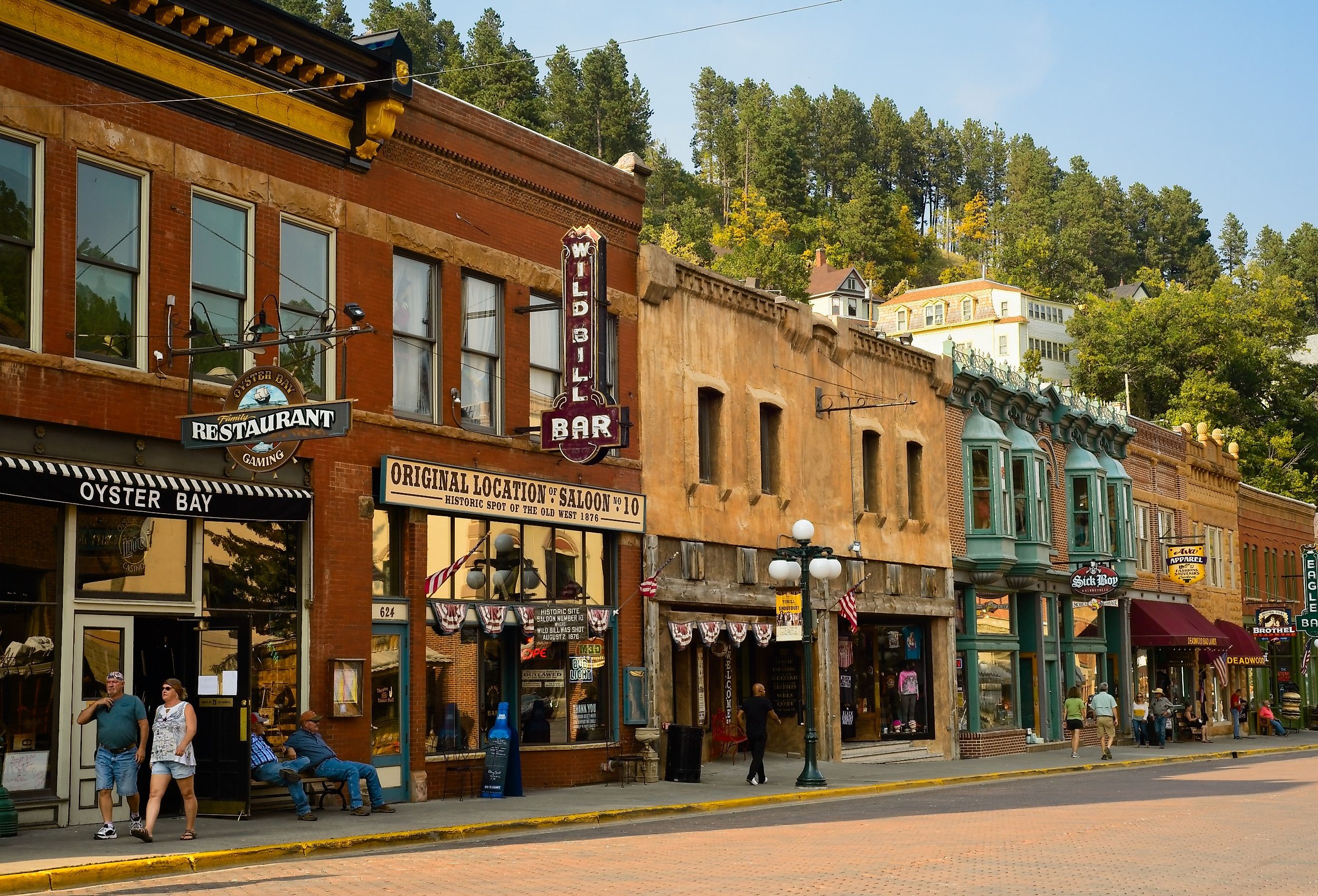 Historic saloons, bars, and shops bring visitors to Main St. in Deadwood, South Dakota. Image credit Kenneth Sponsler via Shutterstock