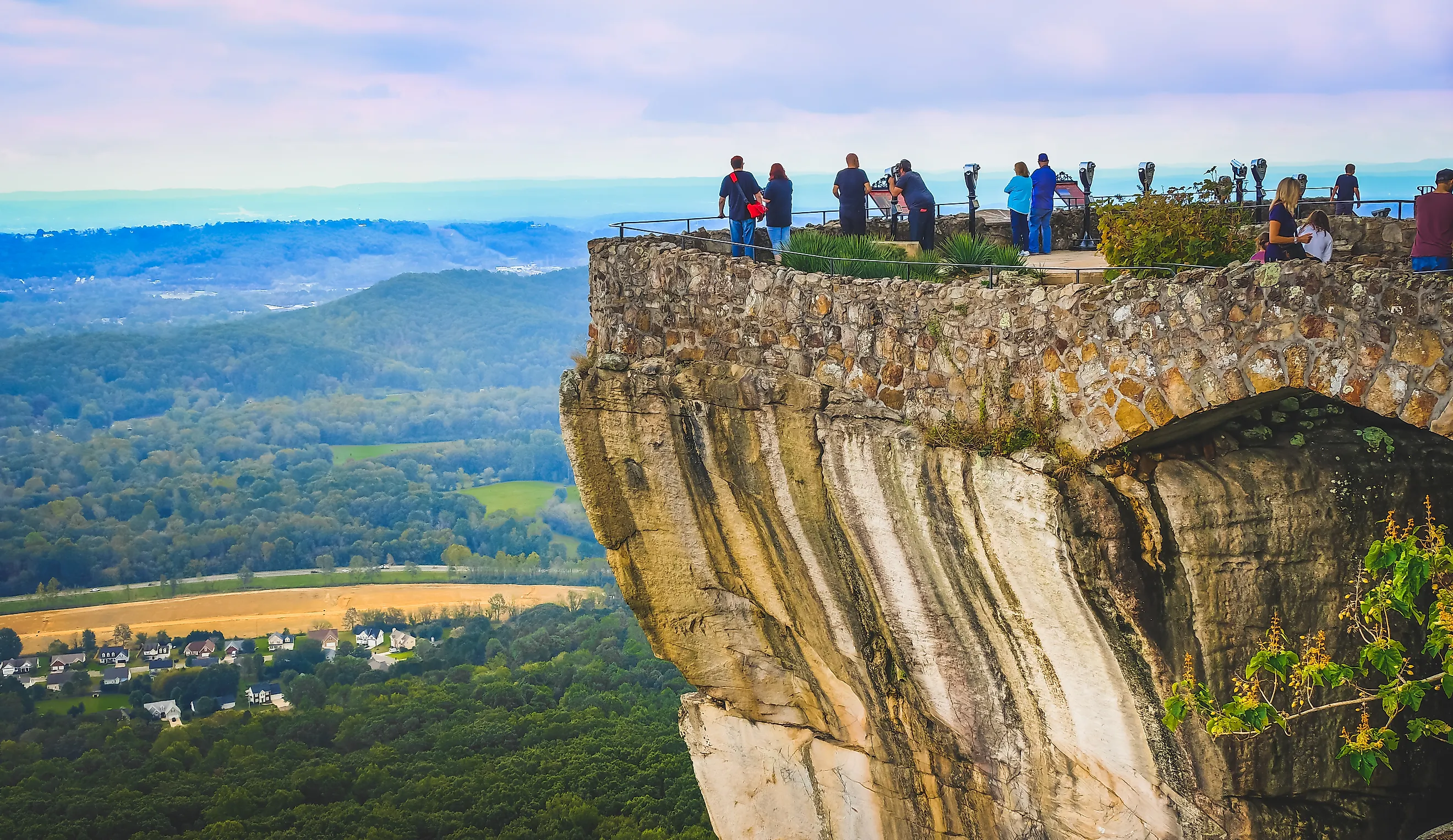 View of Lookout Mountain cliff in Tennessee  with small figures of people looking at the rural landscape underneath in summer 