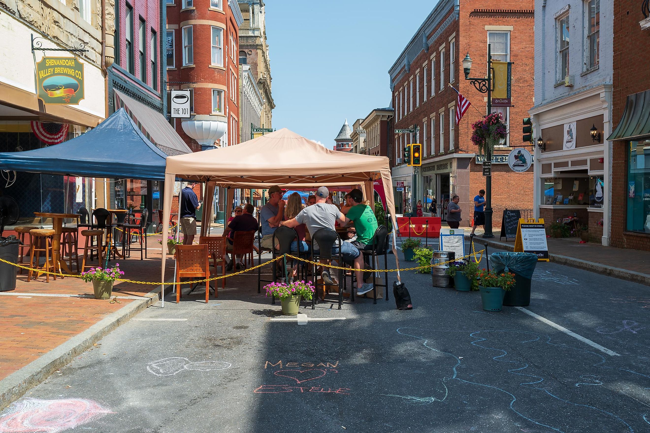 Restaurant patrons dine under the shade of tents on a summer day in Staunton, Virginia