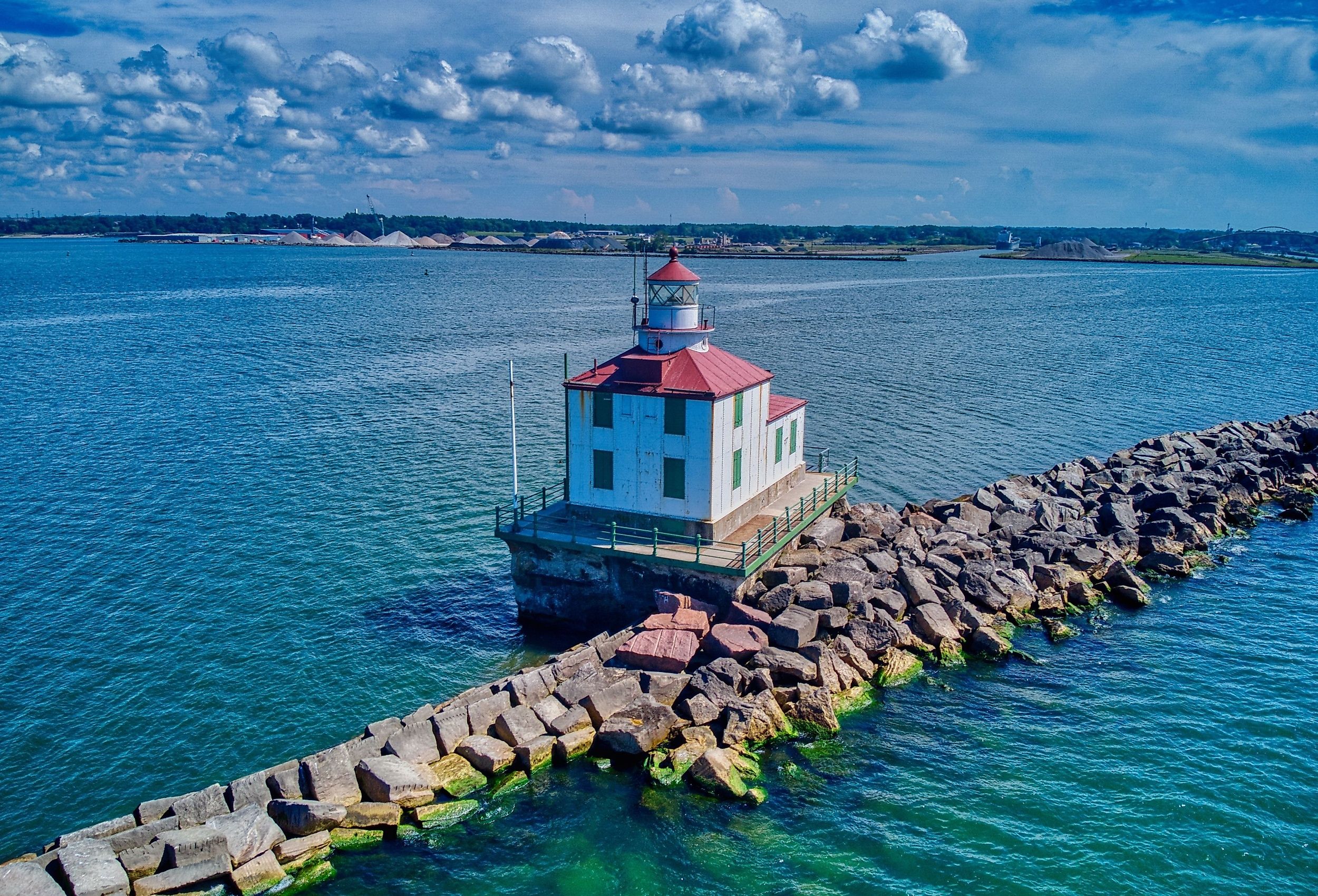 A drone shot of the Ashtabula Harbor Light building under a cloudy sky in Ohio, USA