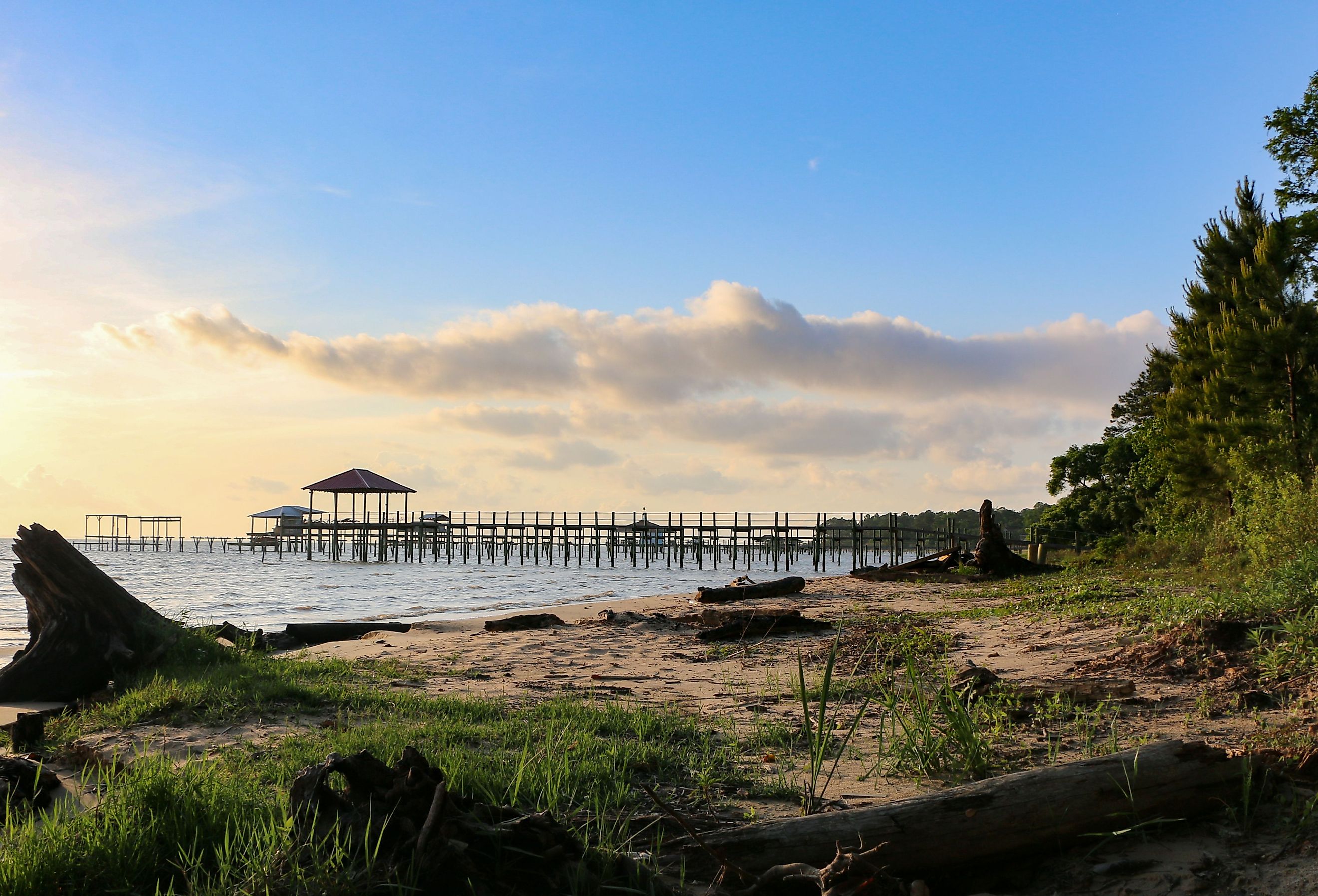 Mobile Bay shoreline Fairhope, Alabama at late afternoon with pier in background