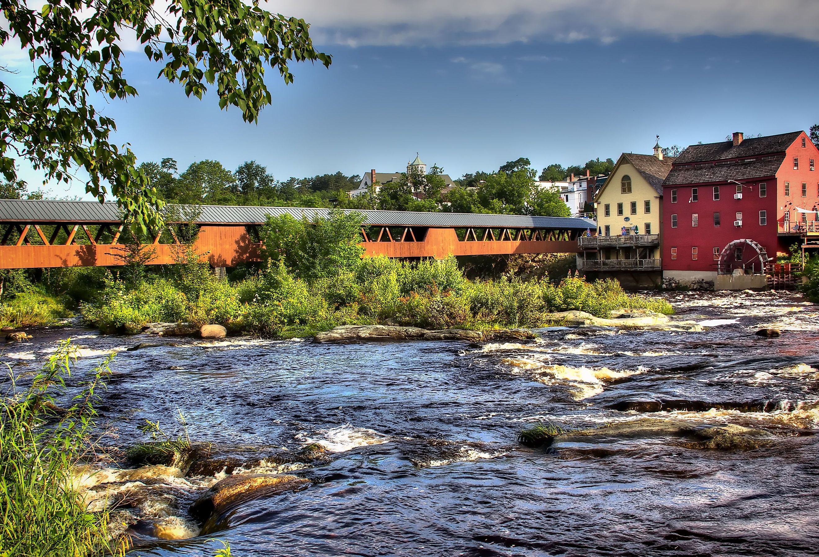 The River Walk Covered Bridge with the Grist mill on the Ammonoosuc River in Littleton, New Hampshire.
