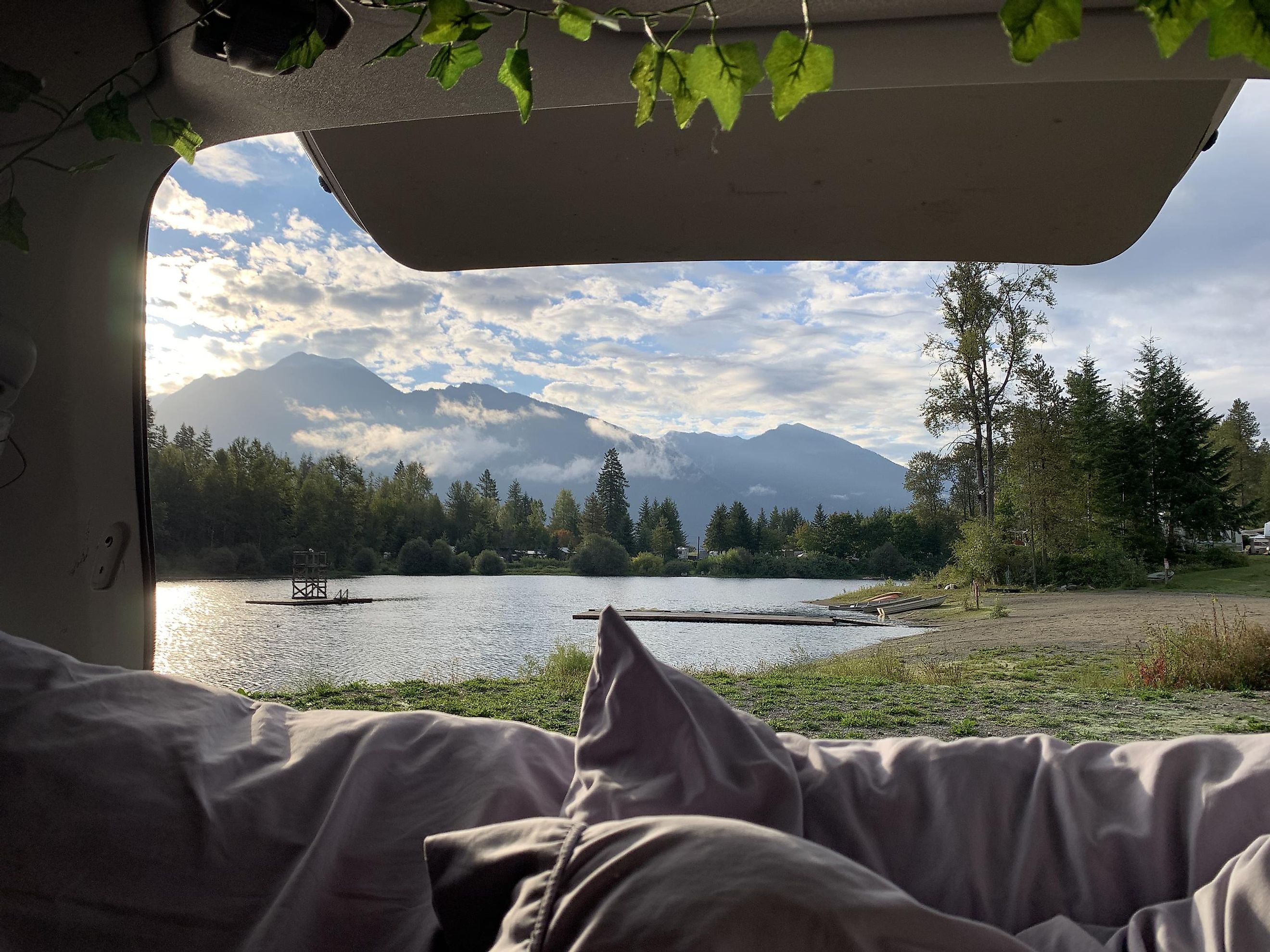Looking out on Mirror Lake, BC, and the surrounding mountains, from the back of a van camping setup. Photo: Irina Lipan