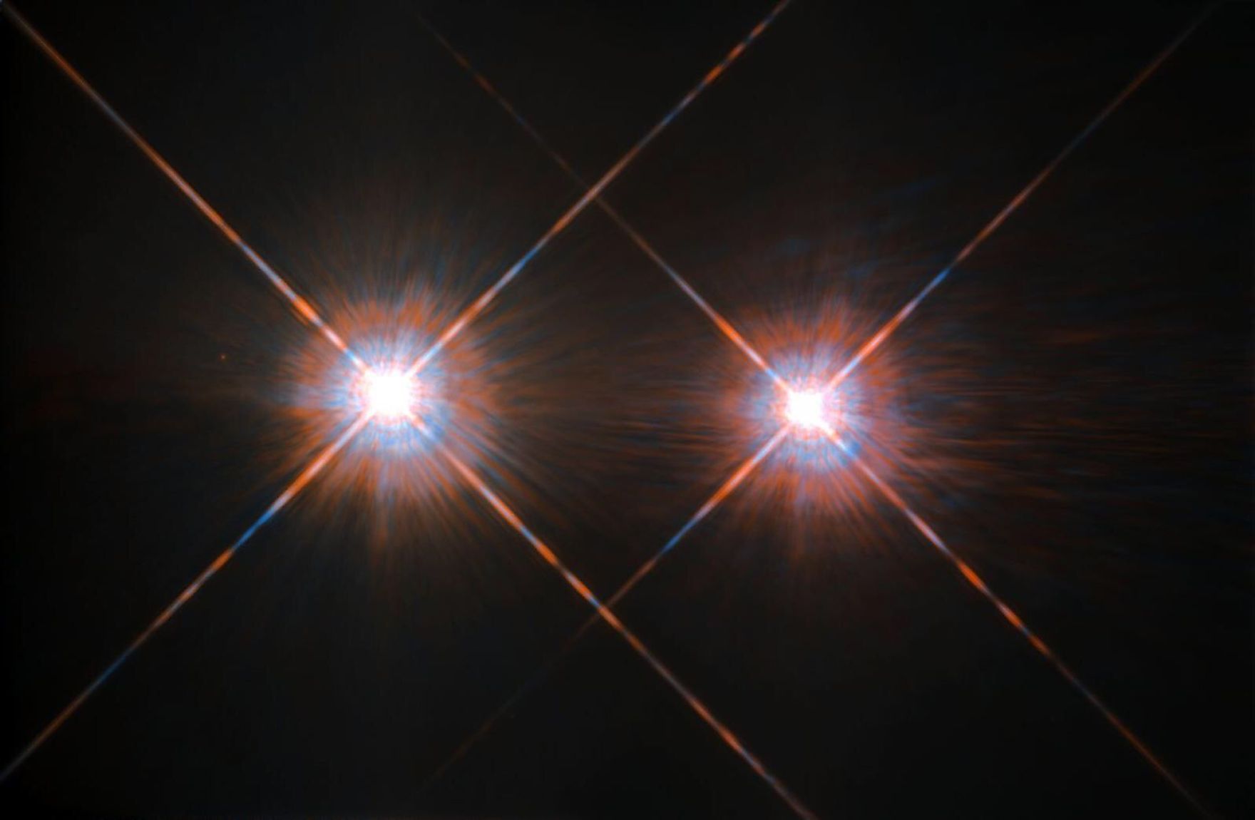 A binary star system containing two red dwarf stars. Image credit: NASA/ESA