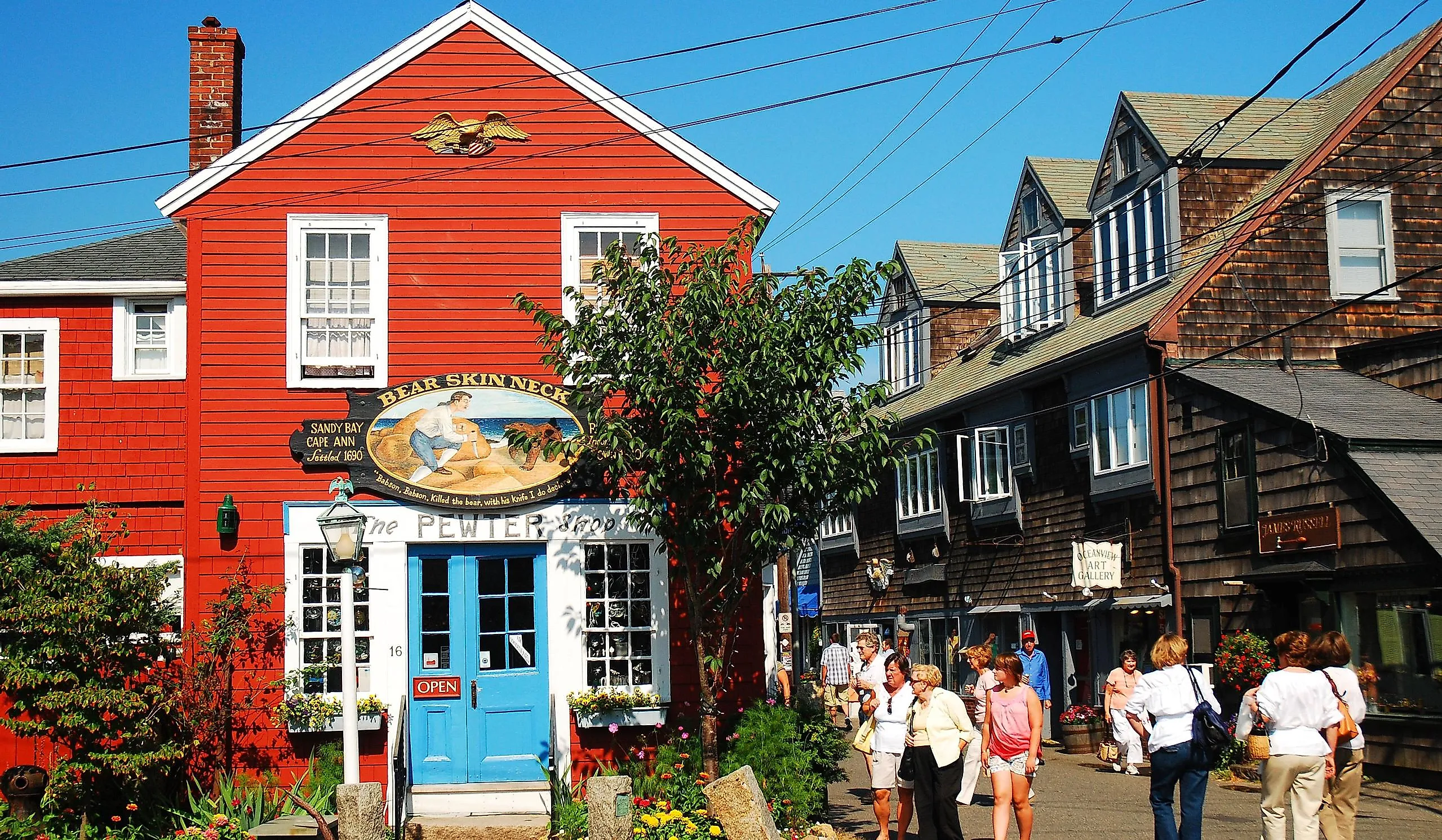 Folks stroll around the unique shops and boutiques on Bearskin Neck in Rockport, Massachusetts. Editorial credit: James Kirkikis / Shutterstock.com