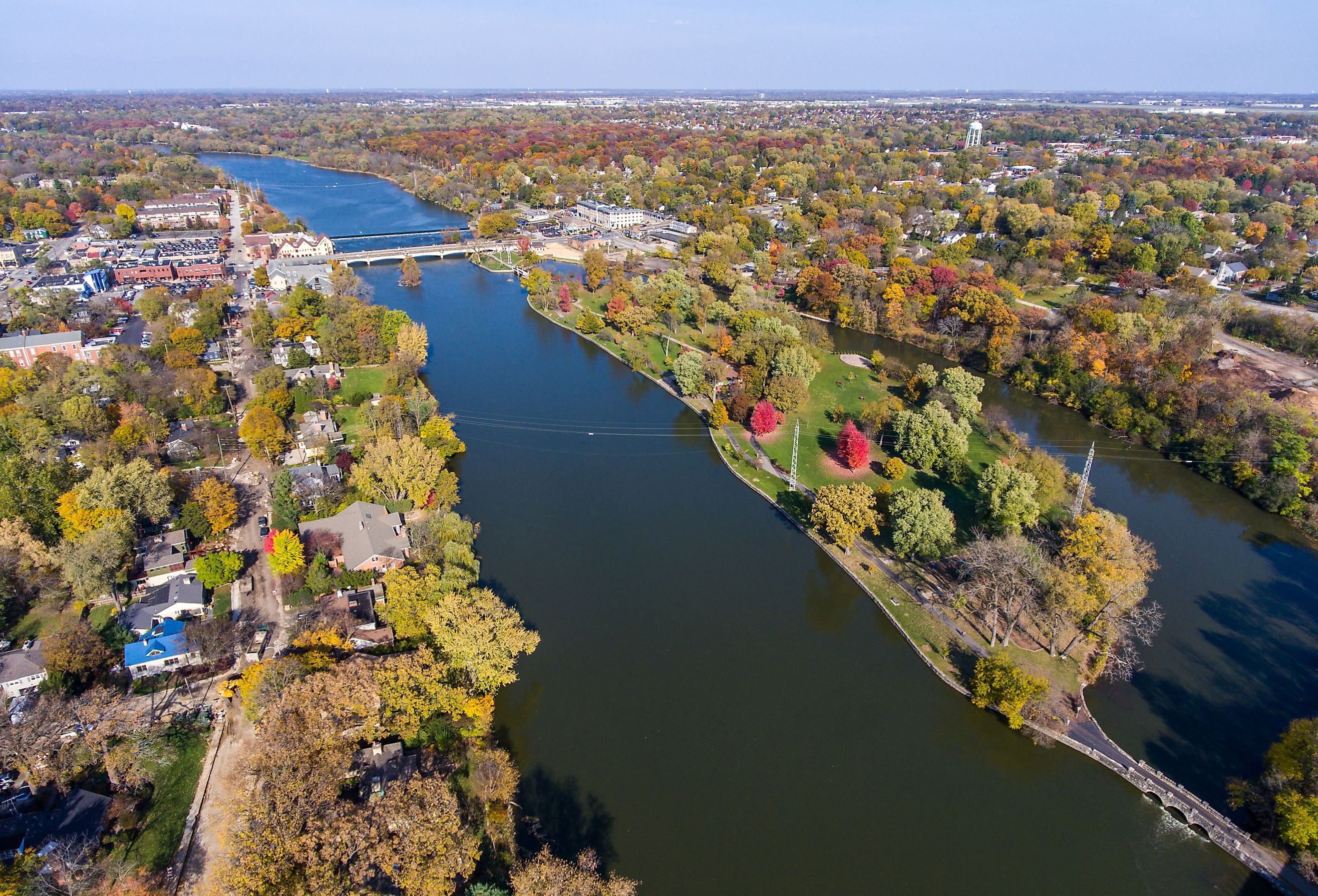 North aerial view of fall foliage and river over Island Park in Geneva, Illinois.