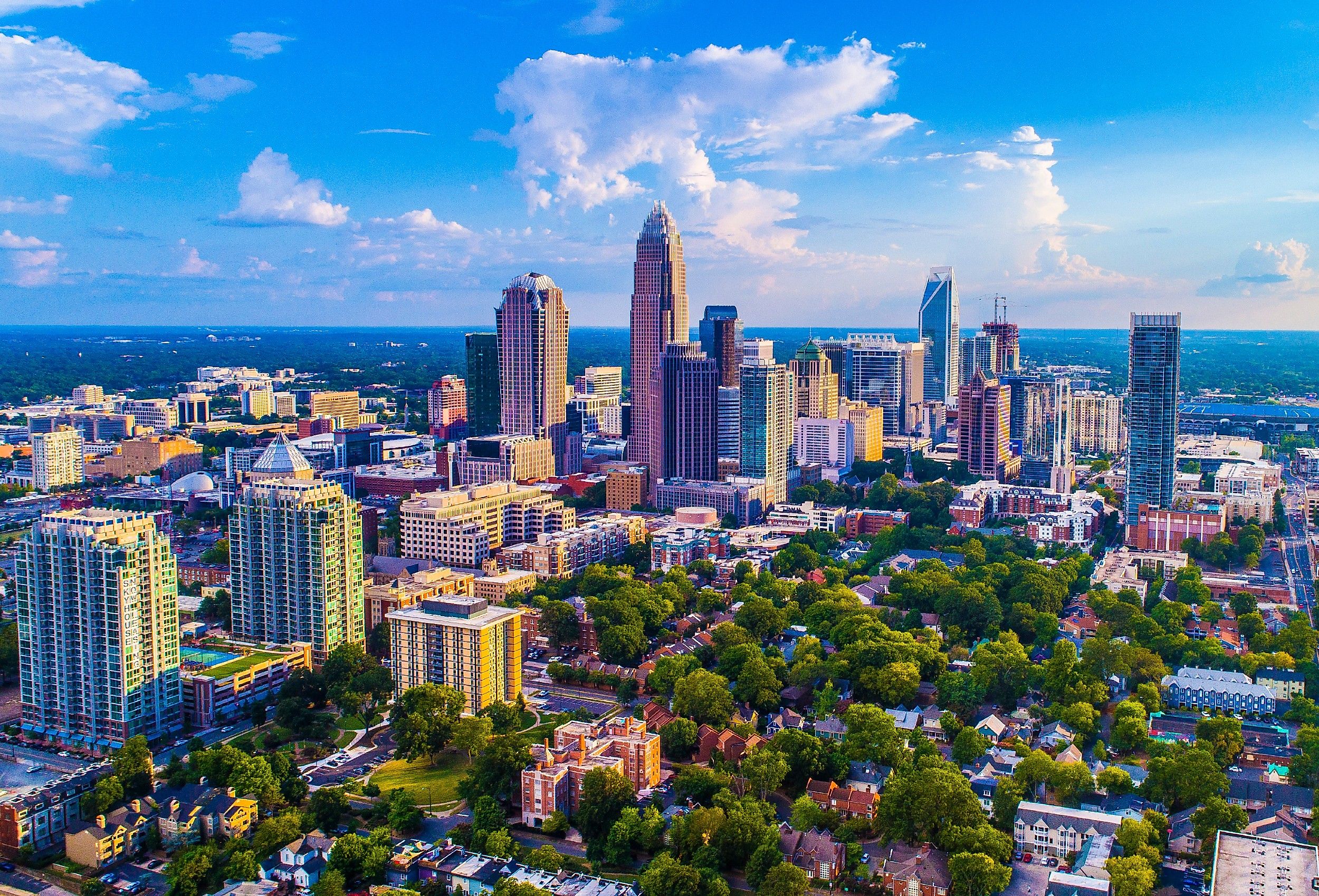 Charlotte North Carolina skyline on a bright sunny day with a few clouds in the sky.