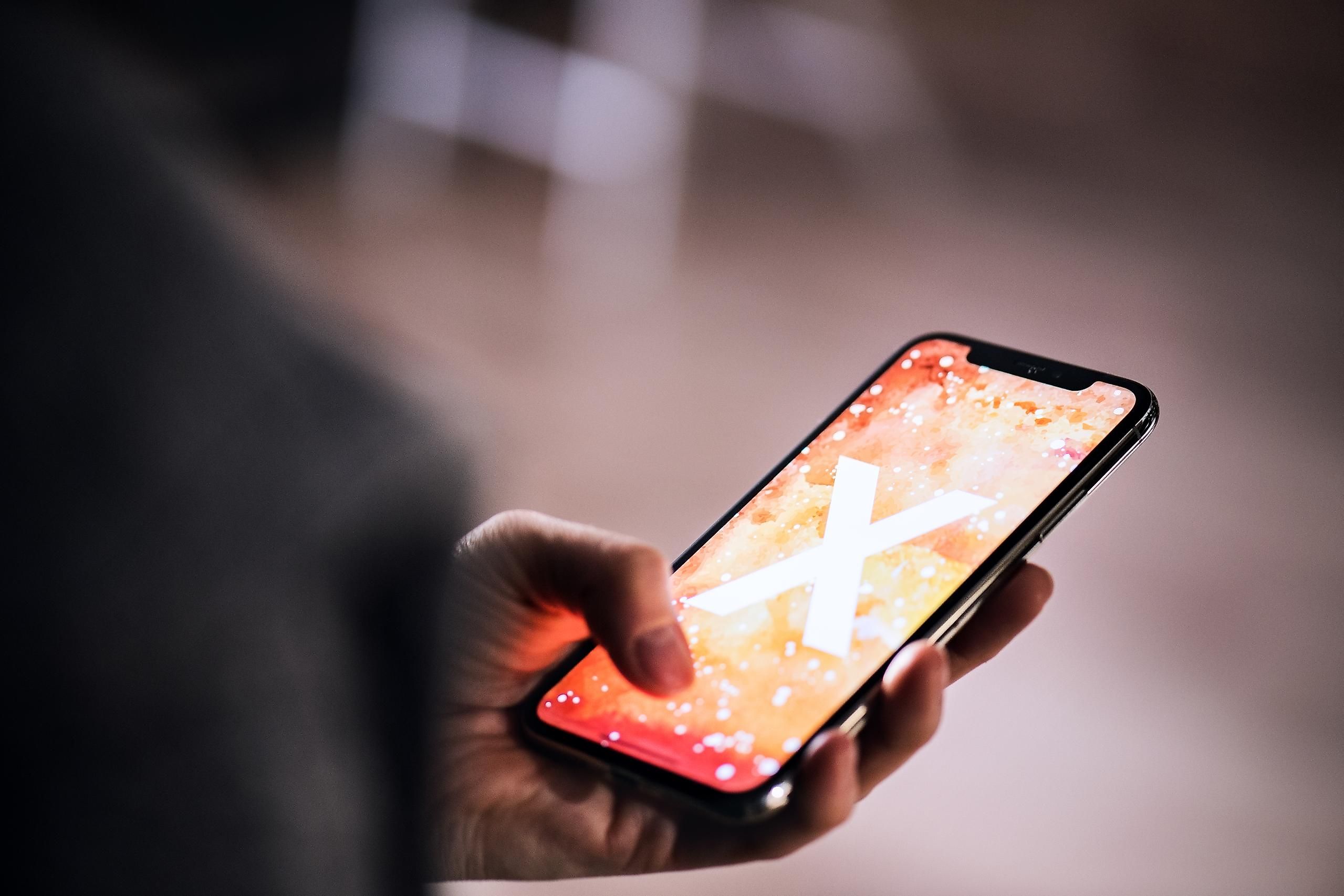 Person holding iPhone. Photo by Halfpoint.
