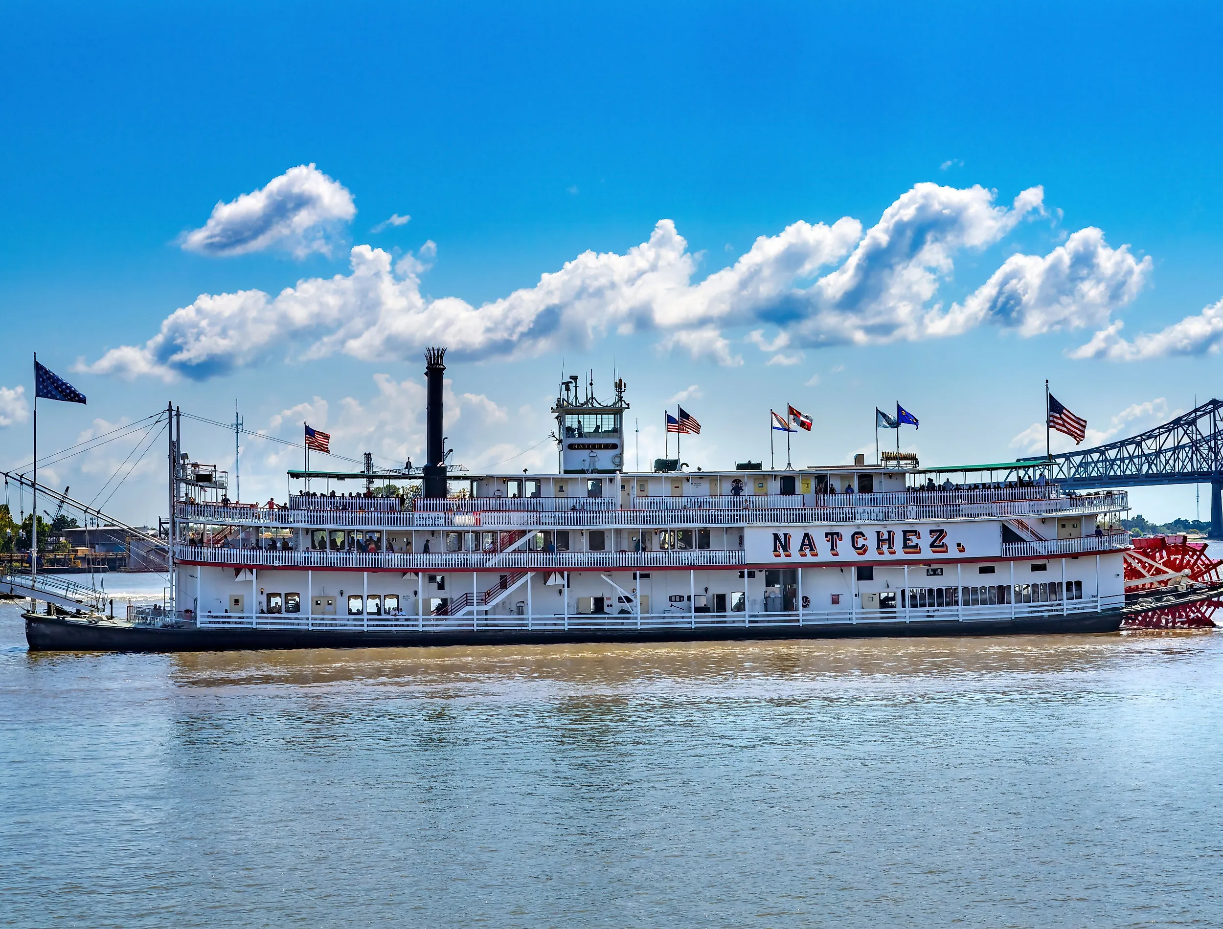 Tourists Natchez Steamboat Riverboat Flags Wharf Mississippi River New Orleans Louisiana. Image credit: Bill Perry via shutterstock